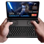 GPD WIN Mini 2024: Powerful handheld gaming PC with 7" FHD 120Hz VRR display. Features AMD Ryzen 7 8840U, 32GB RAM, 2TB NVMe storage. Clamshell design combines full QWERTY keyboard with gaming controls, including dual joysticks and buttons. Compact form factor held comfortably in hands. Screen displays game character with glowing sword, showcasing vibrant graphics. Specs visible: 7" screen, 120Hz VRR, Ryzen 7 8840U, 32GB RAM, 2TB storage. "HANDHELD PC - CLAMSHELL" emphasized. AMD Ryzen and Radeon logos present. Device offers portable gaming and productivity in one, bridging gap between handheld console and mini laptop.