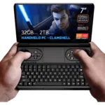 GPD WIN Mini 2024: Powerful handheld gaming PC with 7" FHD 120Hz VRR display. Features AMD Ryzen 7 8840U, 32GB RAM, 2TB NVMe storage. Clamshell design combines full QWERTY keyboard with gaming controls, including dual joysticks and buttons. Compact form factor held comfortably in hands. Screen displays game character with glowing sword, showcasing vibrant graphics. Specs visible: 7" screen, 120Hz VRR, Ryzen 7 8840U, 32GB RAM, 2TB storage. "HANDHELD PC - CLAMSHELL" emphasized. AMD Ryzen and Radeon logos present. Device offers portable gaming and productivity in one, bridging gap between handheld console and mini laptop.