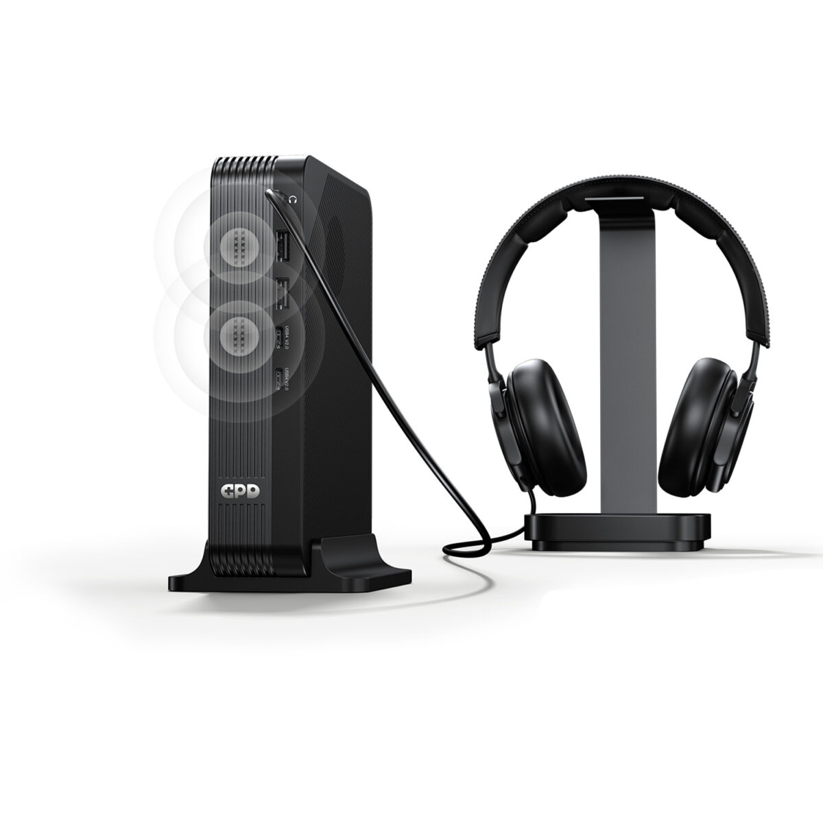 A marketing image showing the GPD device vertically docked. A cable connects its top audio jack to a pair of black over-ear headphones sitting on a stand. Faint white concentric circles emanate from the front of the unit, illustrating the built-in speaker functionality alongside the wired audio output.